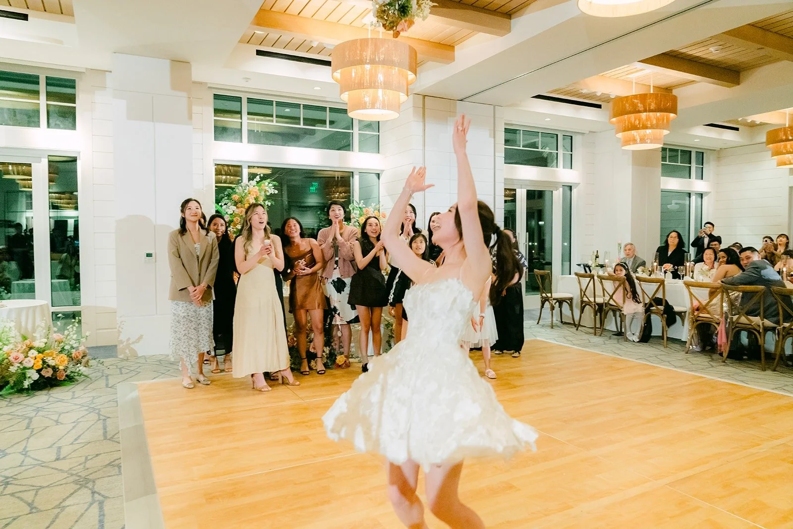 Angela tossing her bouquet over her shoulder