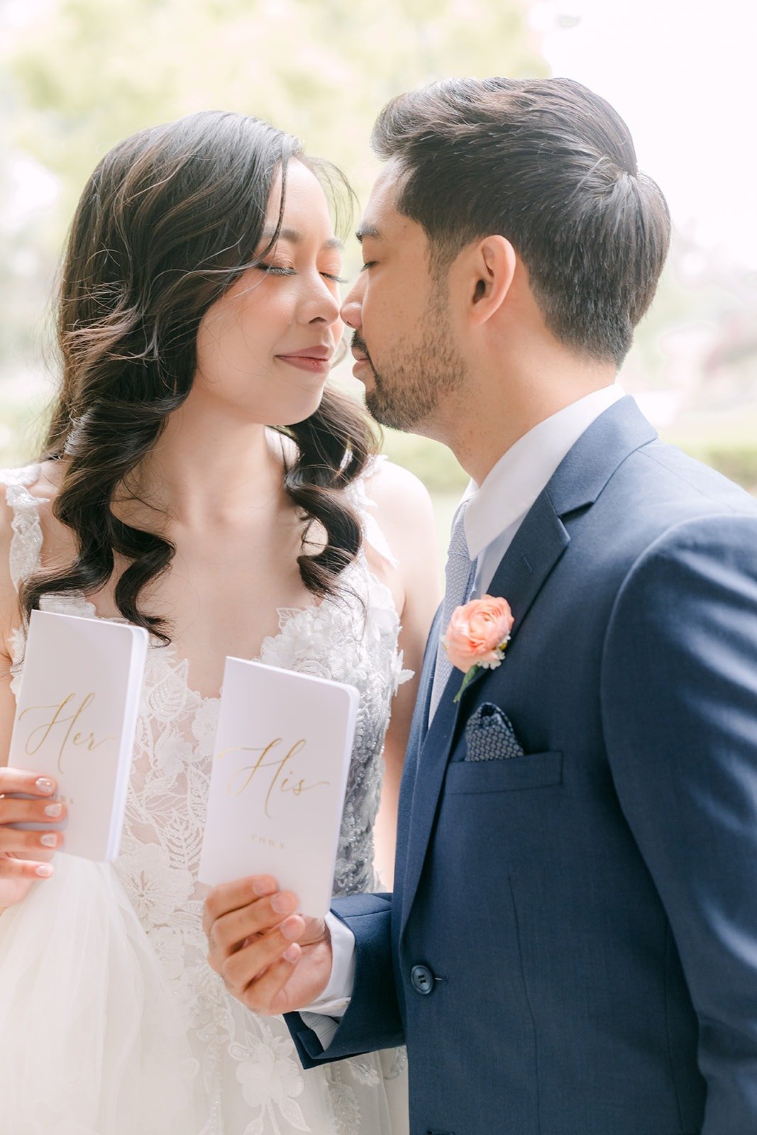 Natalie and Mark sharing a quiet moment with their vow cards in hand, photographed by One and Only Production