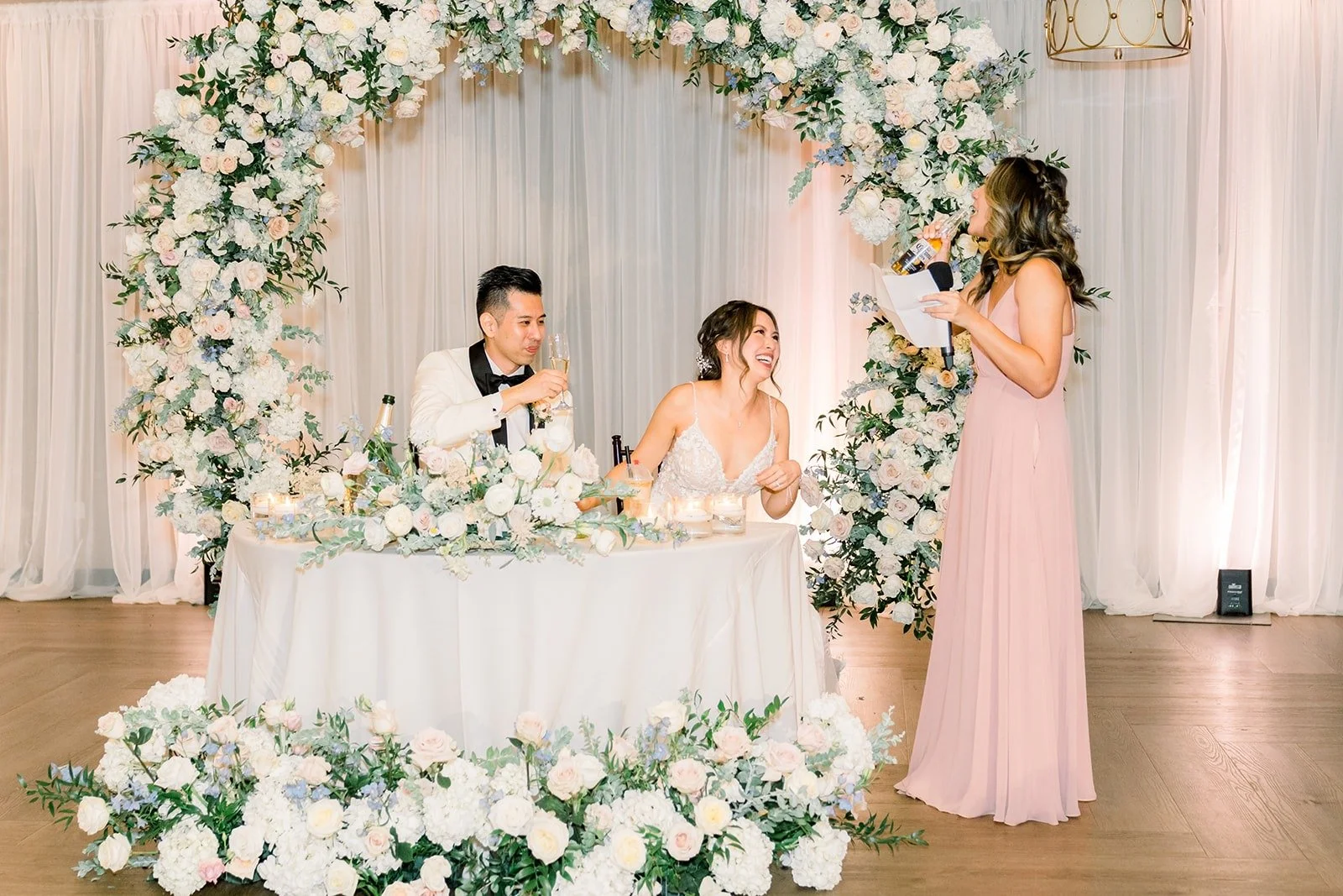 A toast delivered beside the floral arch
