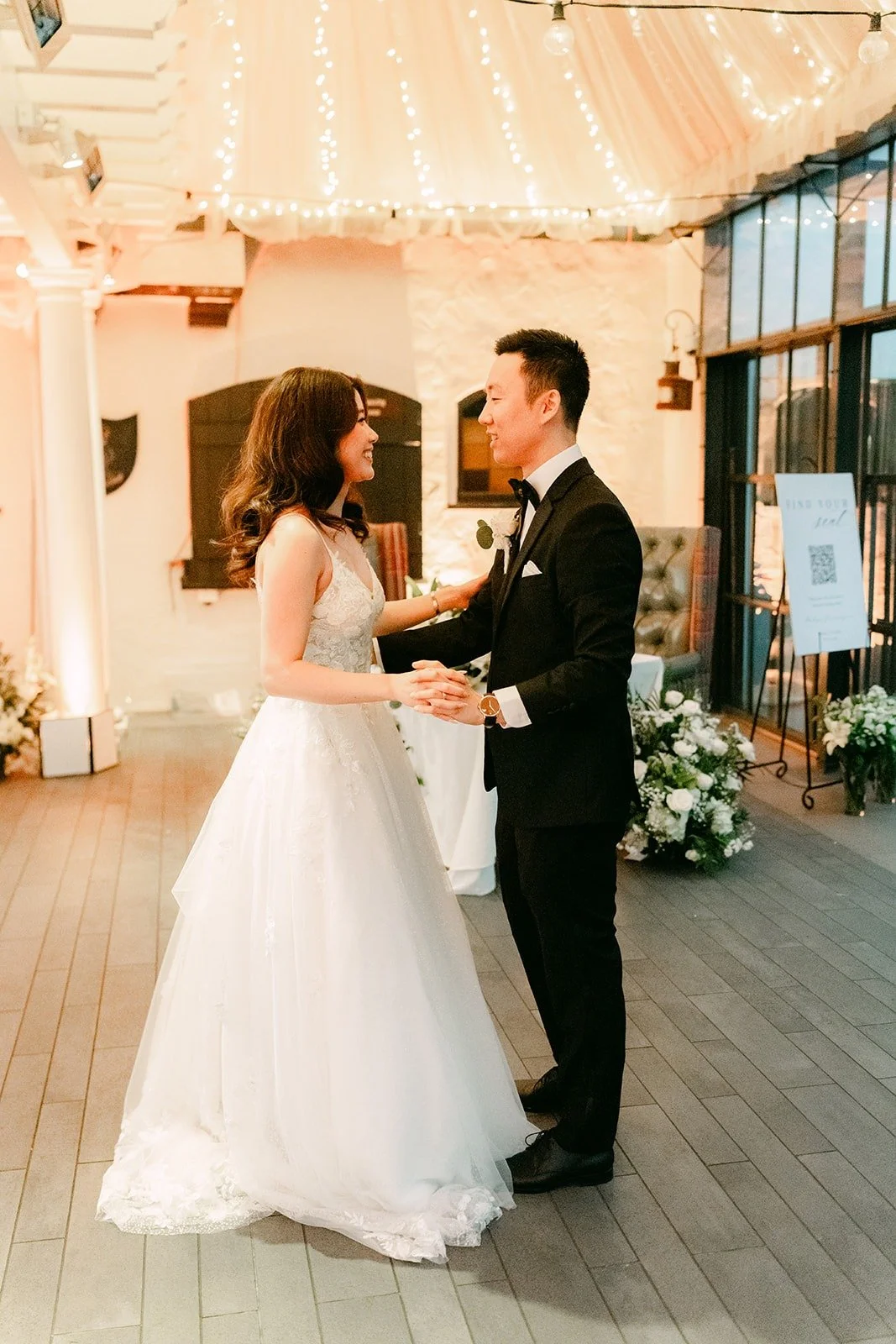 Valerie and Jason holding hands as they sway