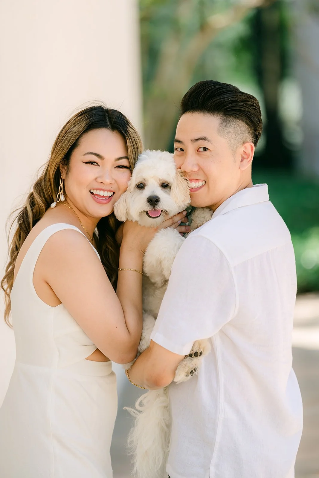 Stephanie and Alan smile with Tofu between them.
