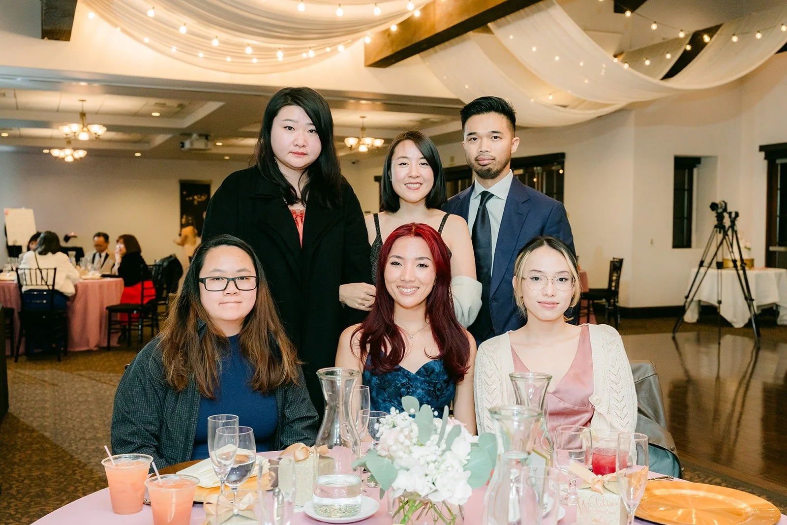 Guests smiling for a table photo with the couple