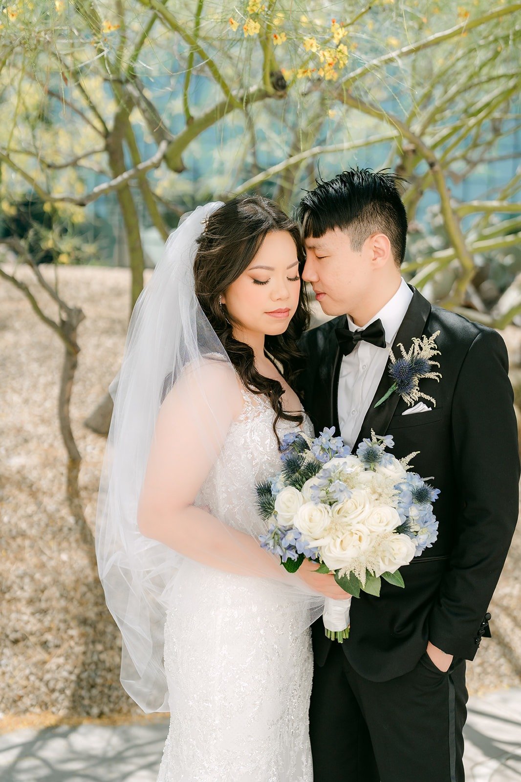 James kissing Emily's forehead as she holds her bouquet