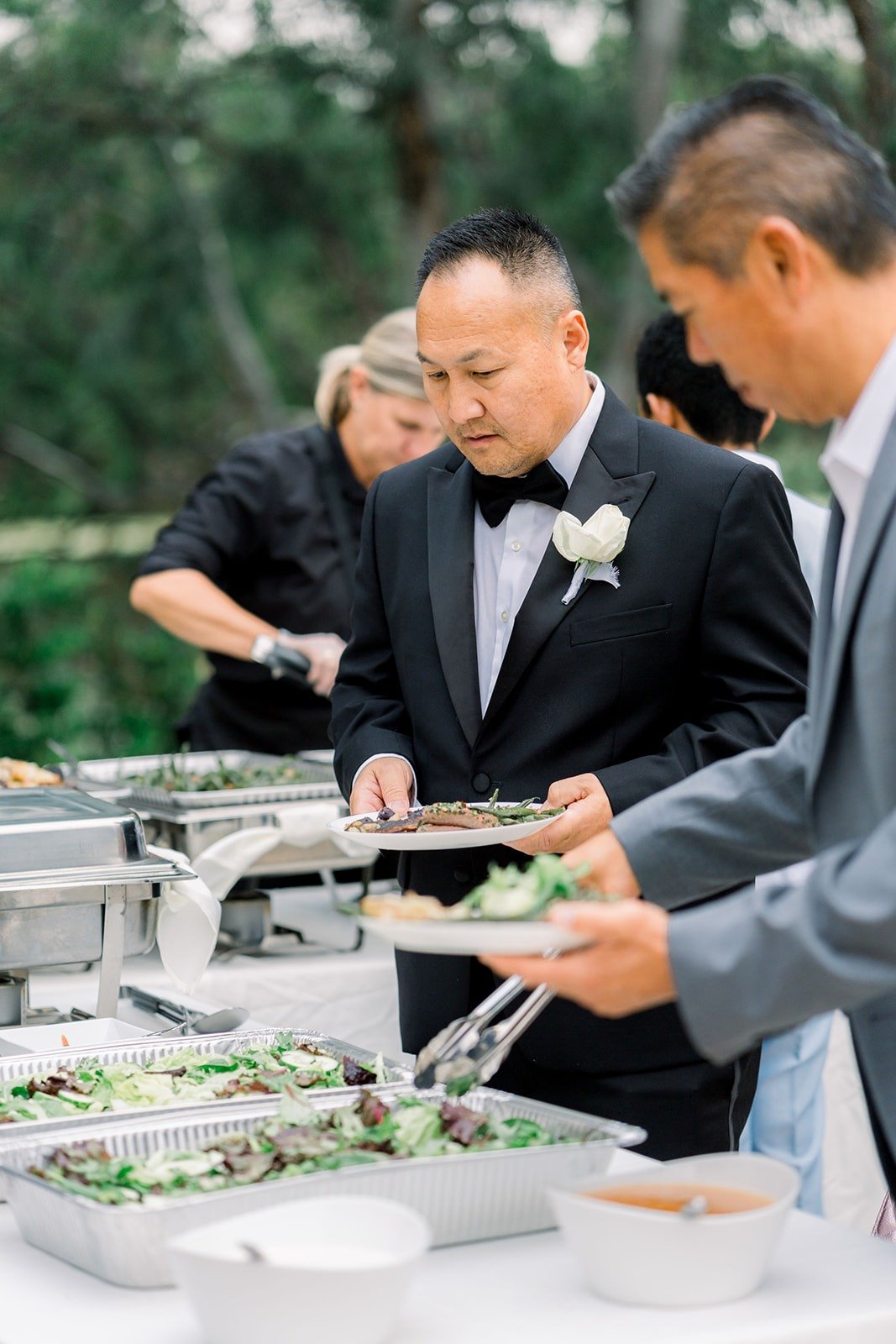 Steven serves himself at the dinner buffet