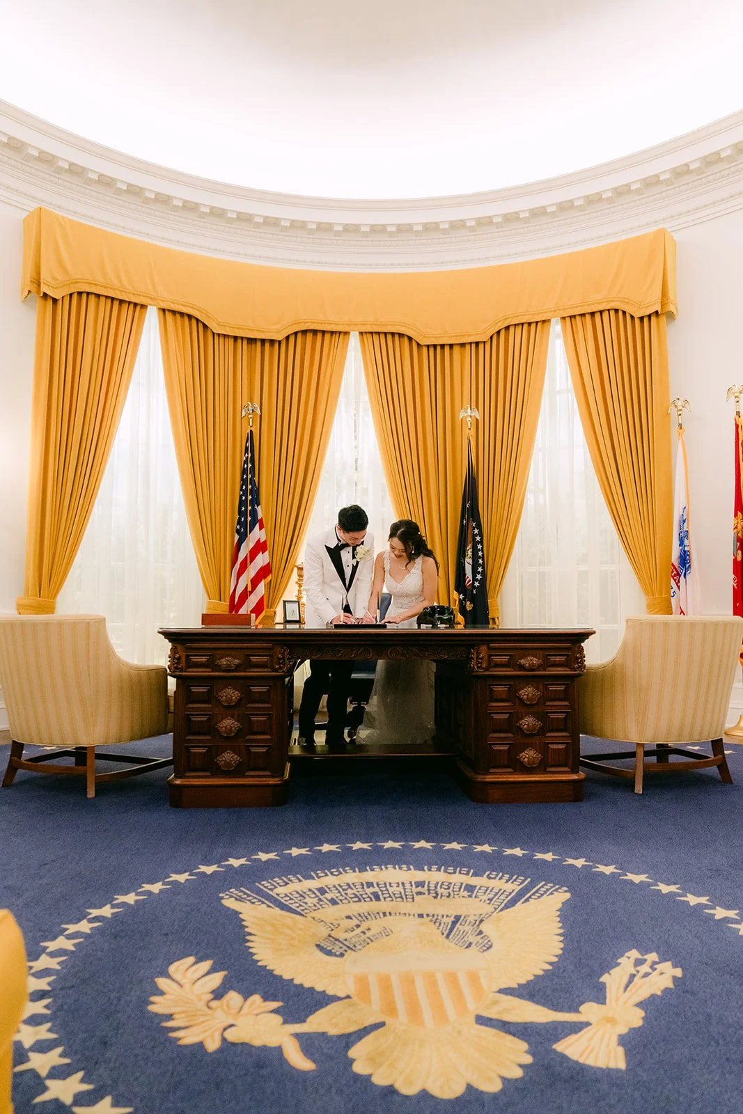 Jenny and Ryan at the desk in the Oval Office replica at the Nixon Library.