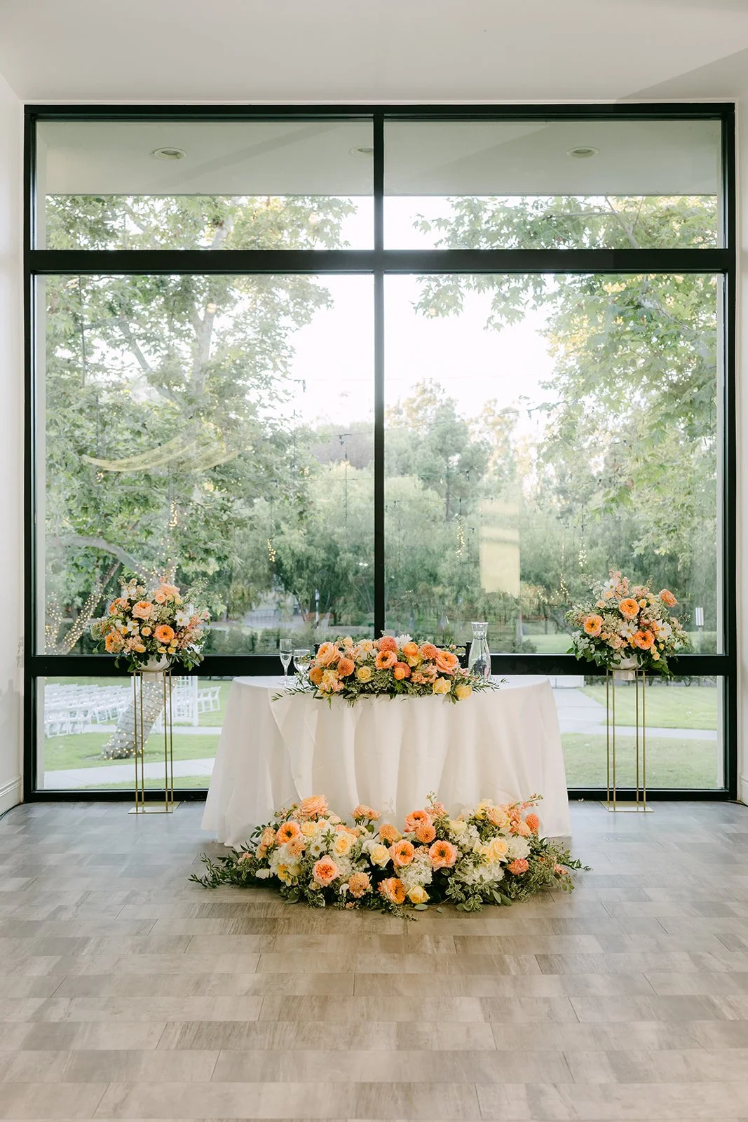 Sweetheart table in front of the ballroom windows