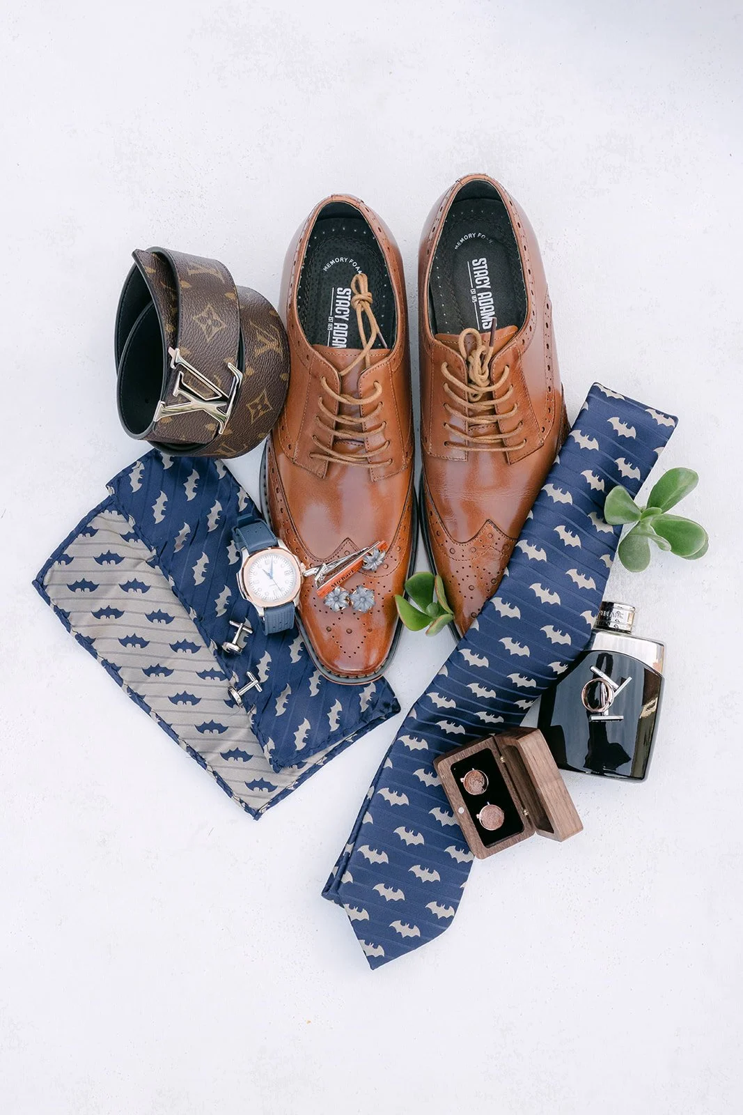 Michael's brown shoes, navy ties and cufflinks laid out together.