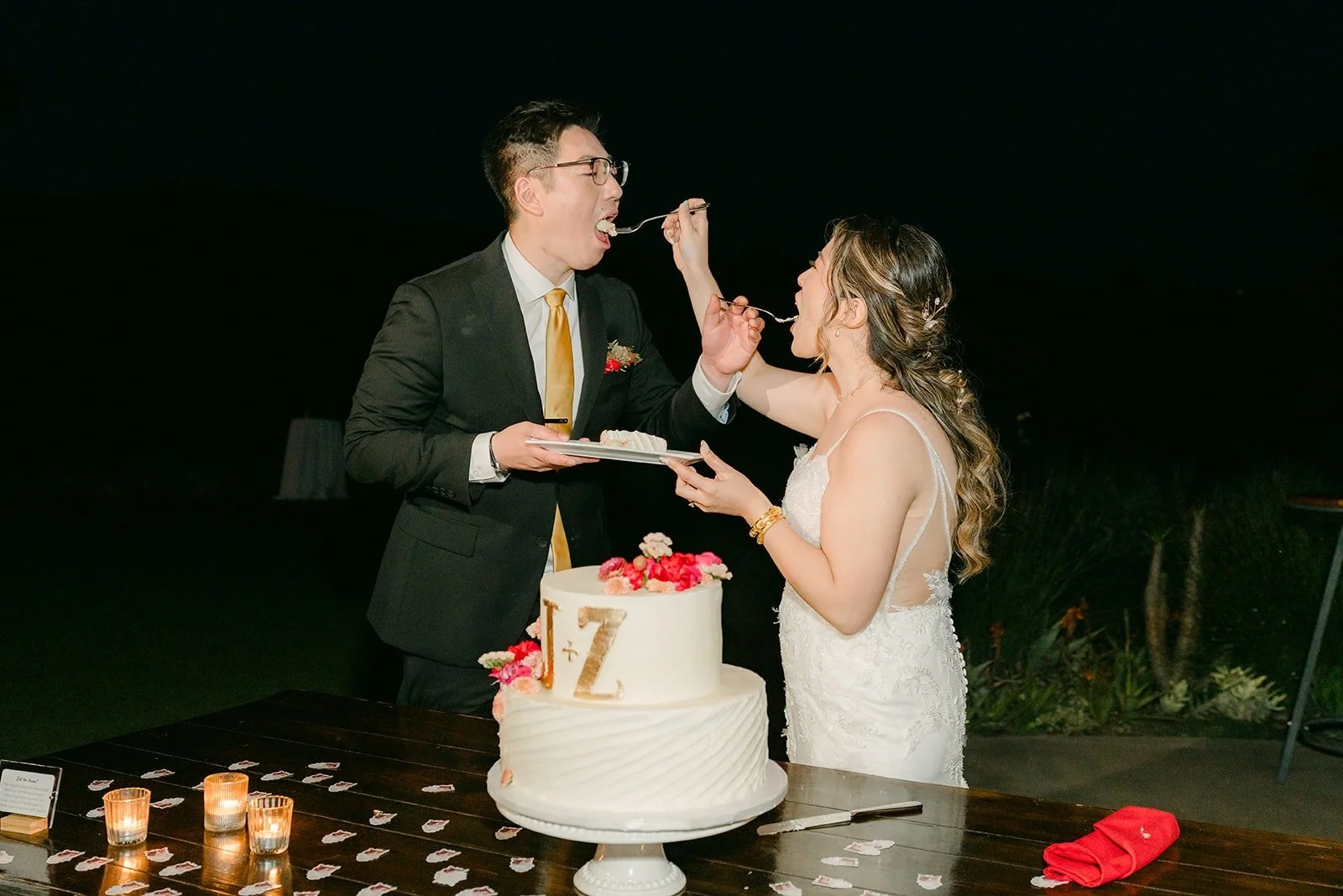 Zach feeding Joanne a bite of cake at night