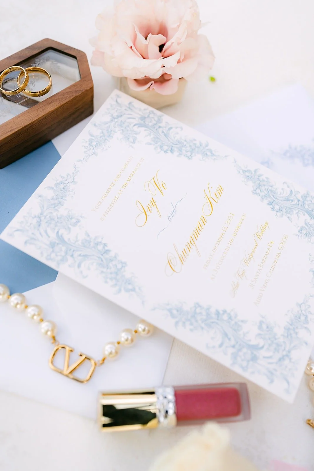 Ivy and Chungman's blue toile invitation with the ring box
