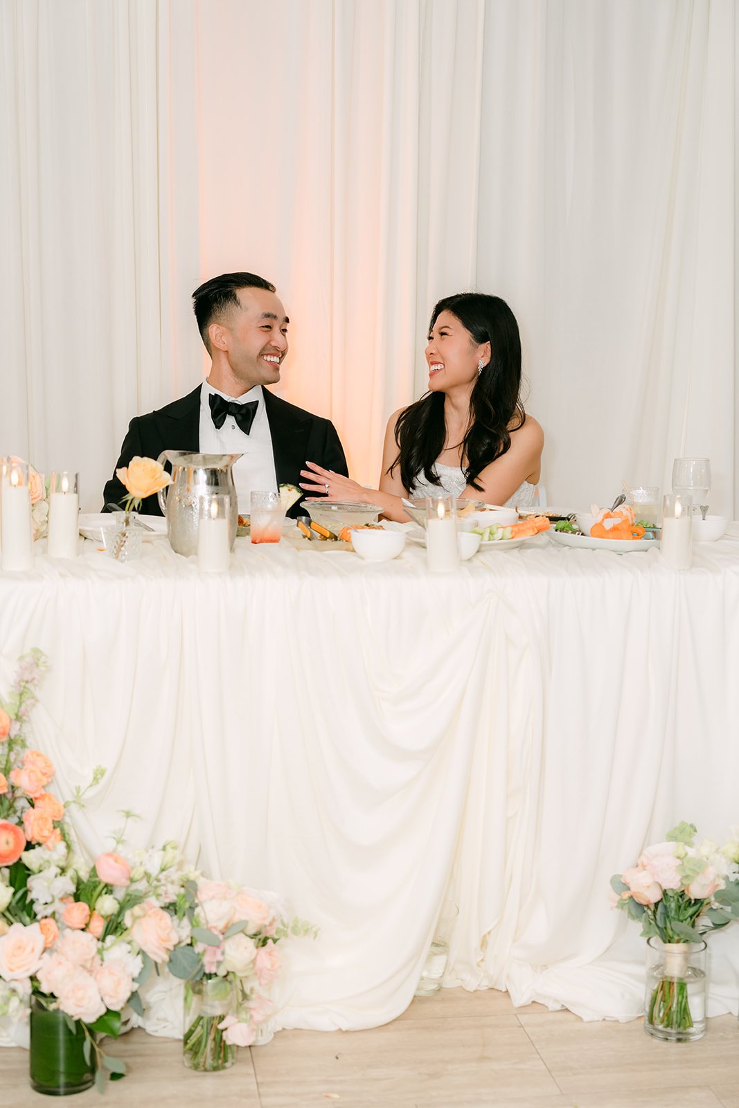 Kim and Vincent laughing during a toast