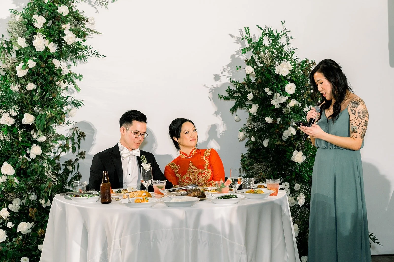 Cindy and Alex at the sweetheart table during speeches