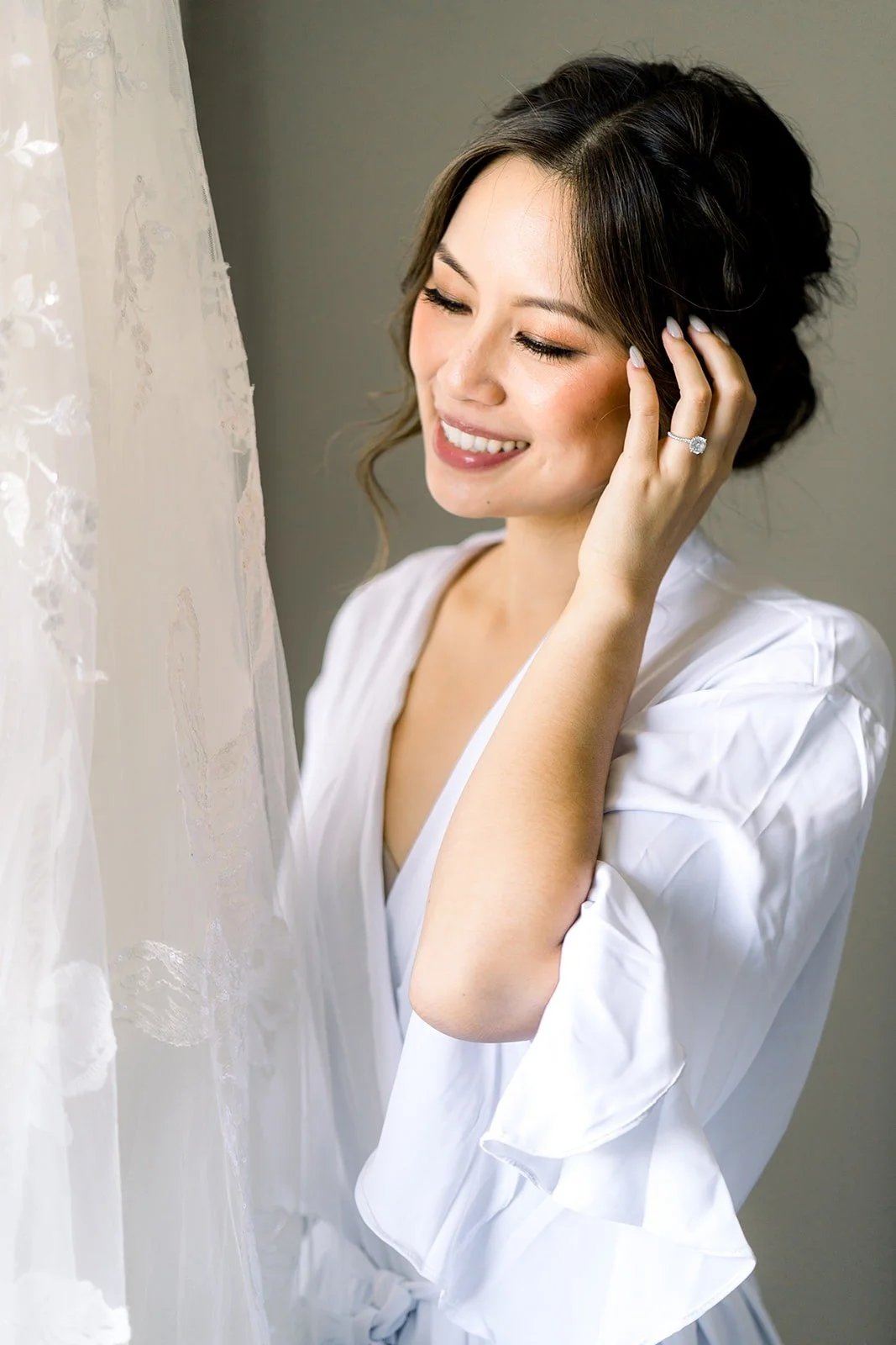 Josephine laughing as she touches her hair