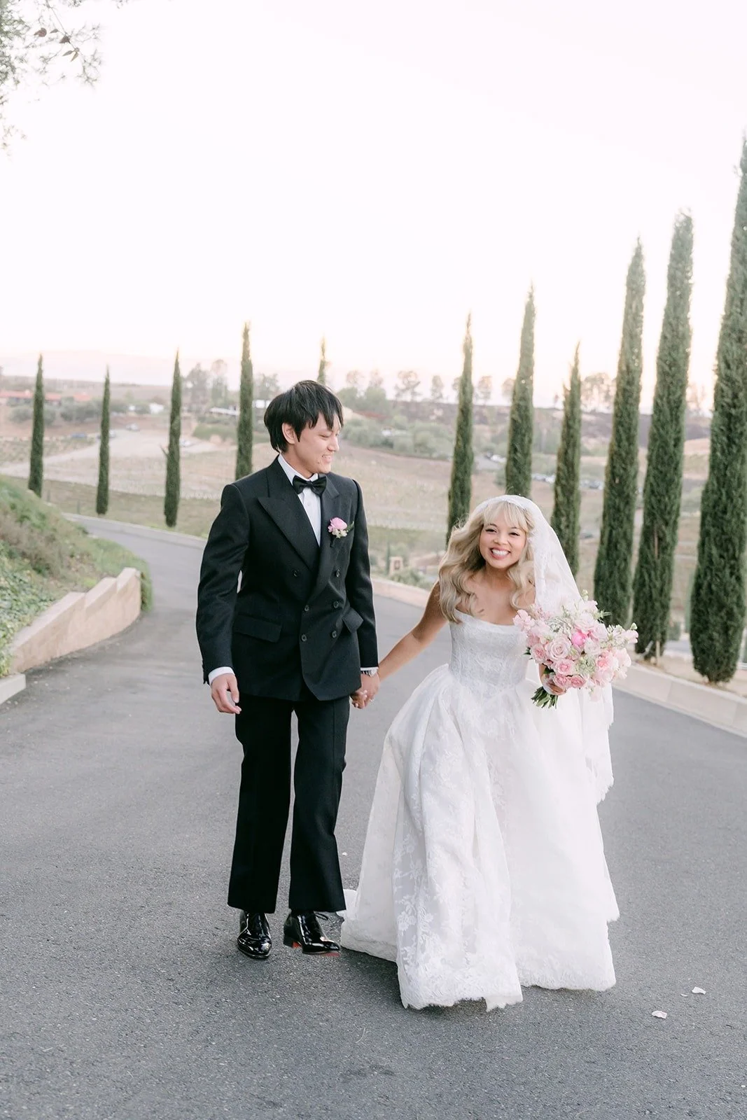 Konitha and Job laughing as they walk along the drive at Bel Vino Winery