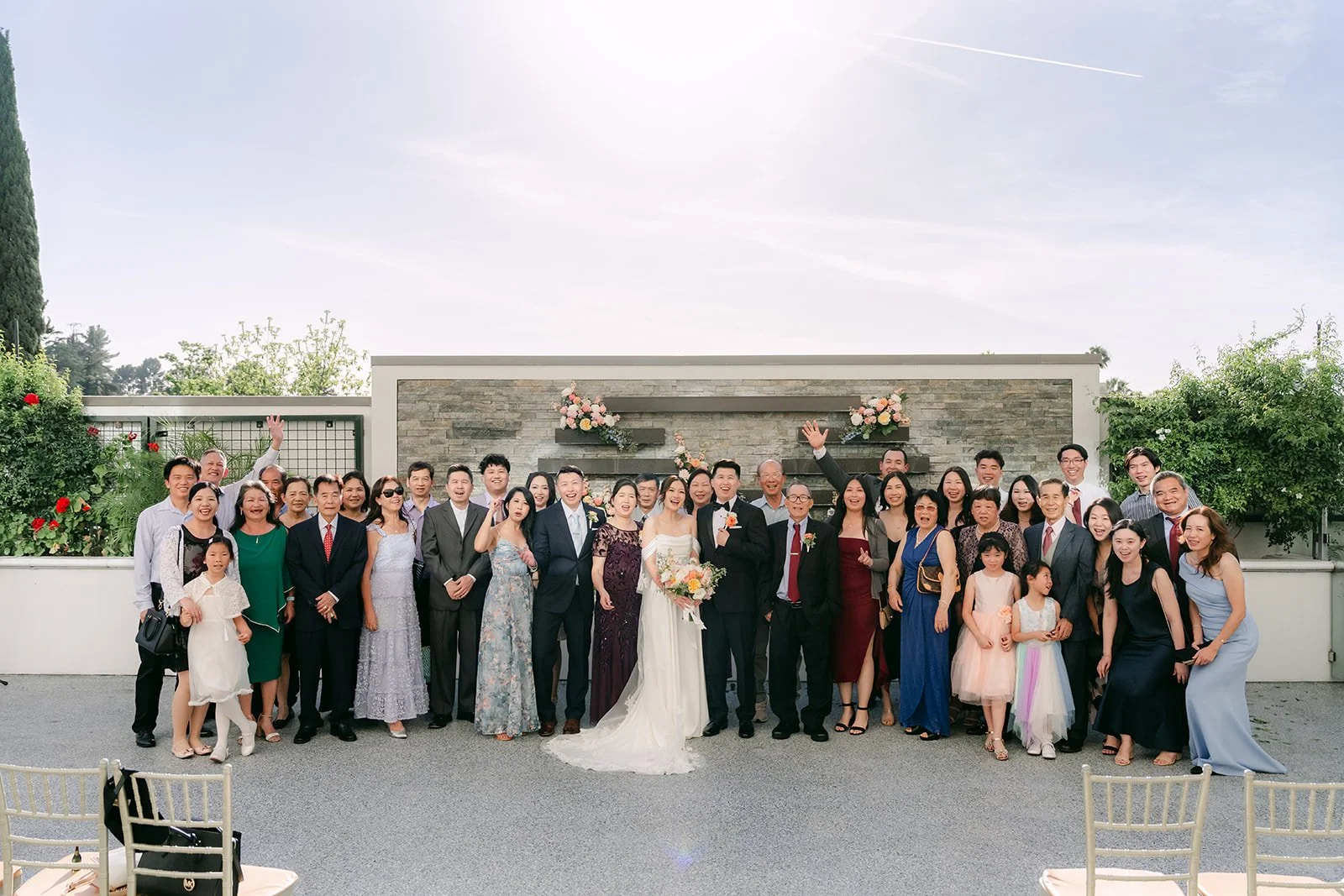 Amanda and San with all of their guests in a big group photo, photographed by One and Only Production.