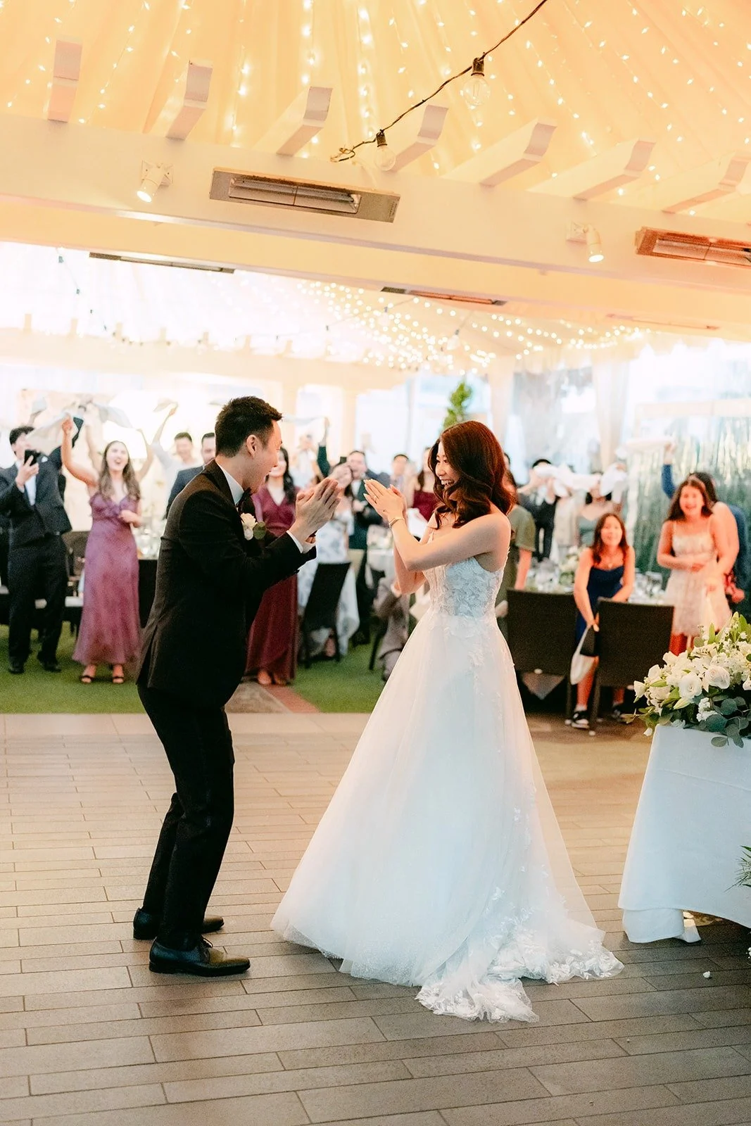 Valerie and Jason beginning their first dance under the draped canopy