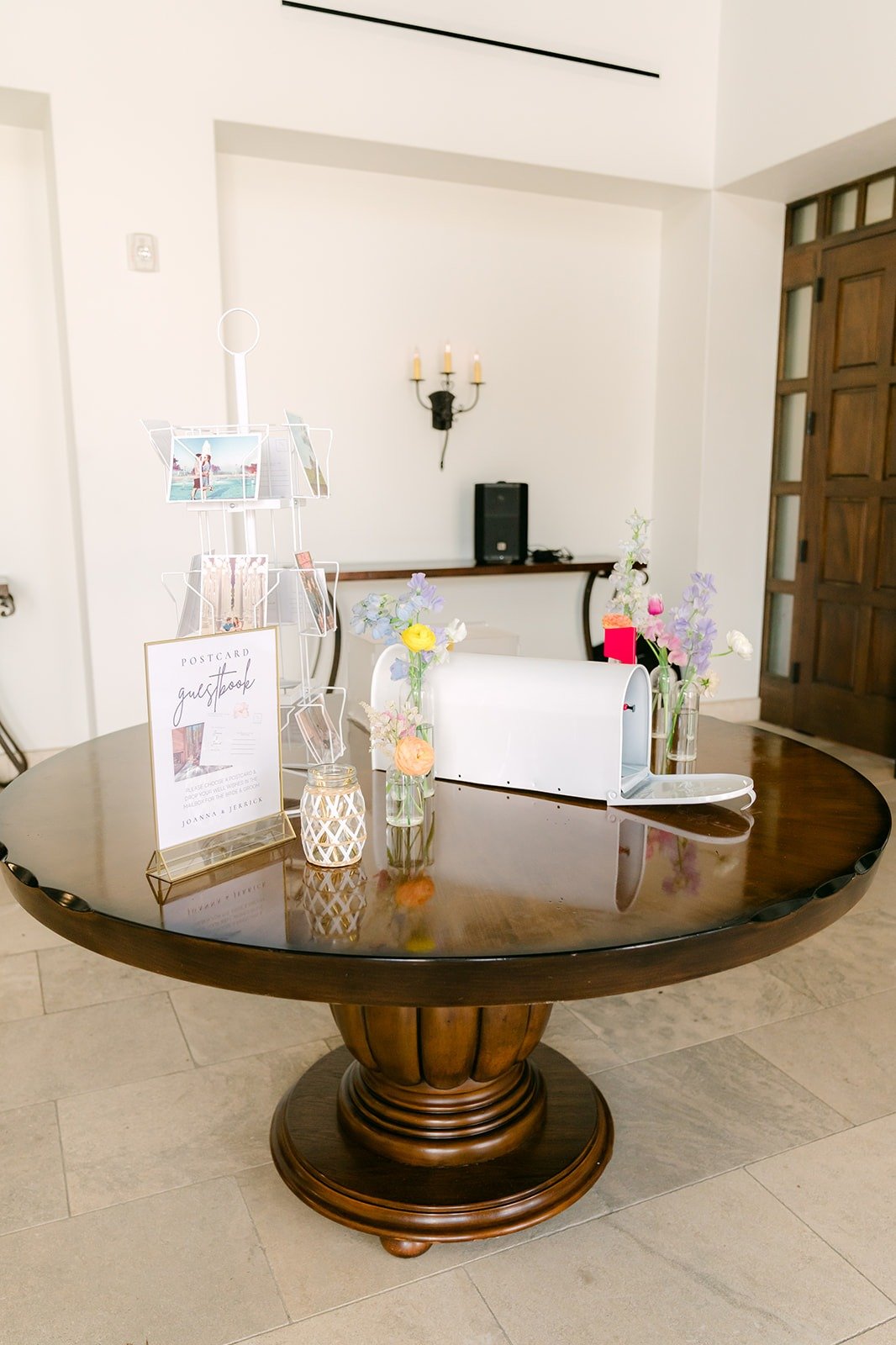 The card table on a round wooden pedestal at the parlor entry