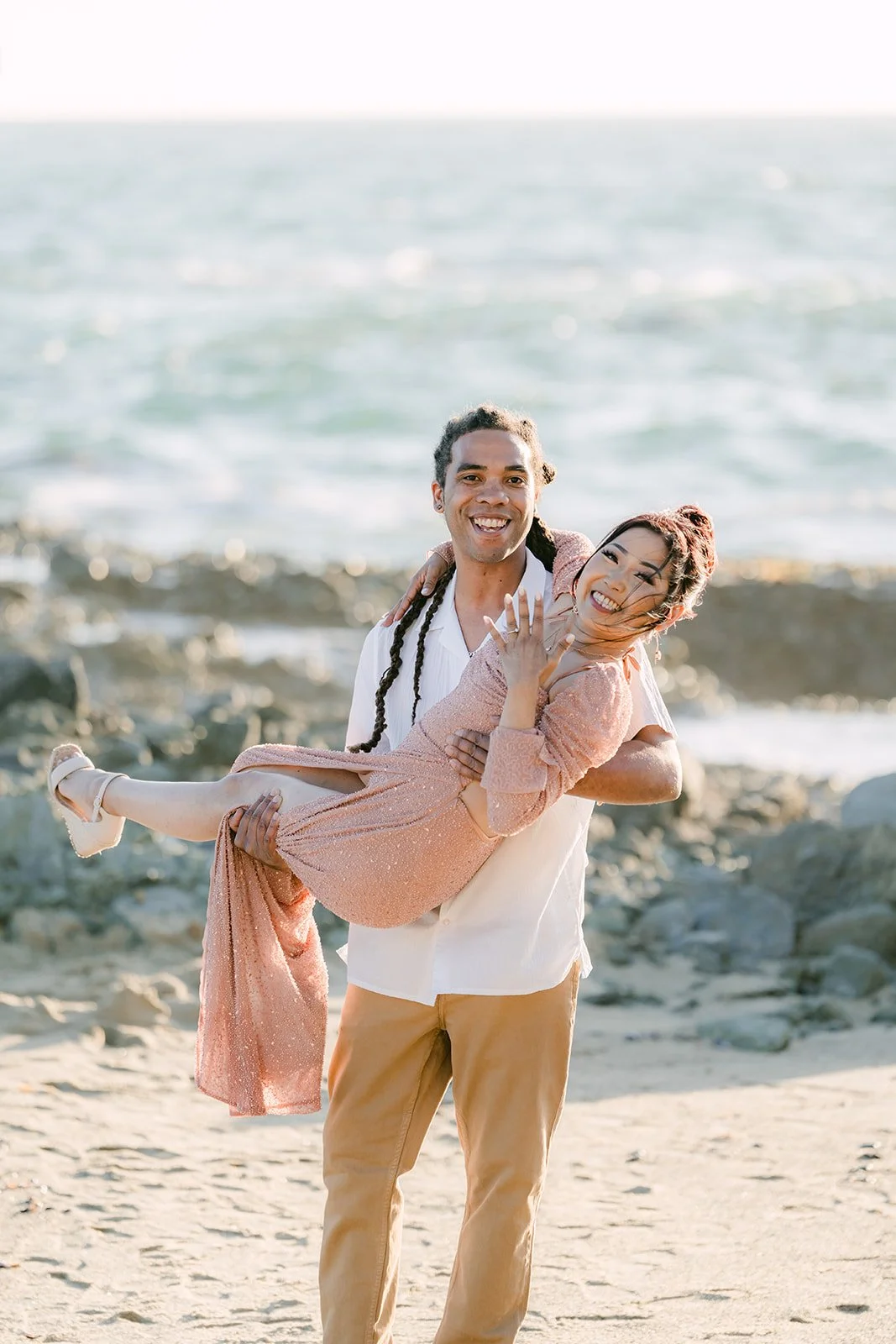 Michael carrying Amy on the beach.