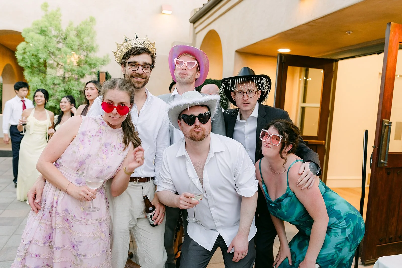 Guests in silly props posing at the photo booth