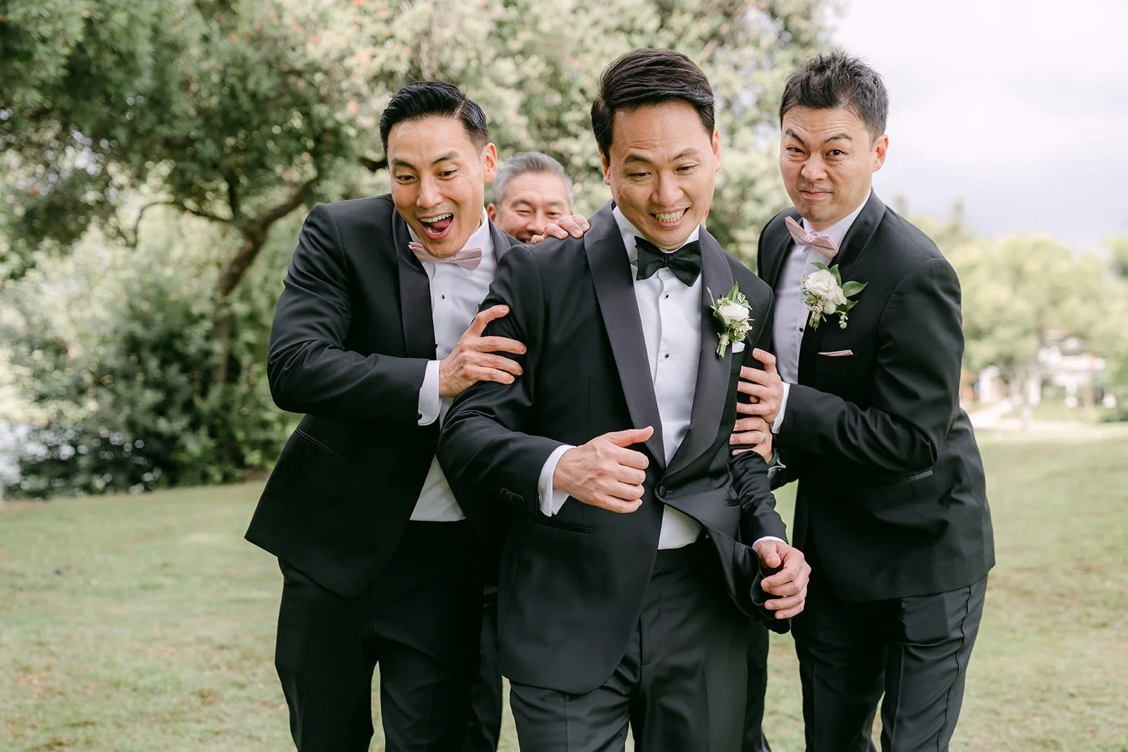 William and his groomsmen sharing a laugh, photographed by One and Only Production