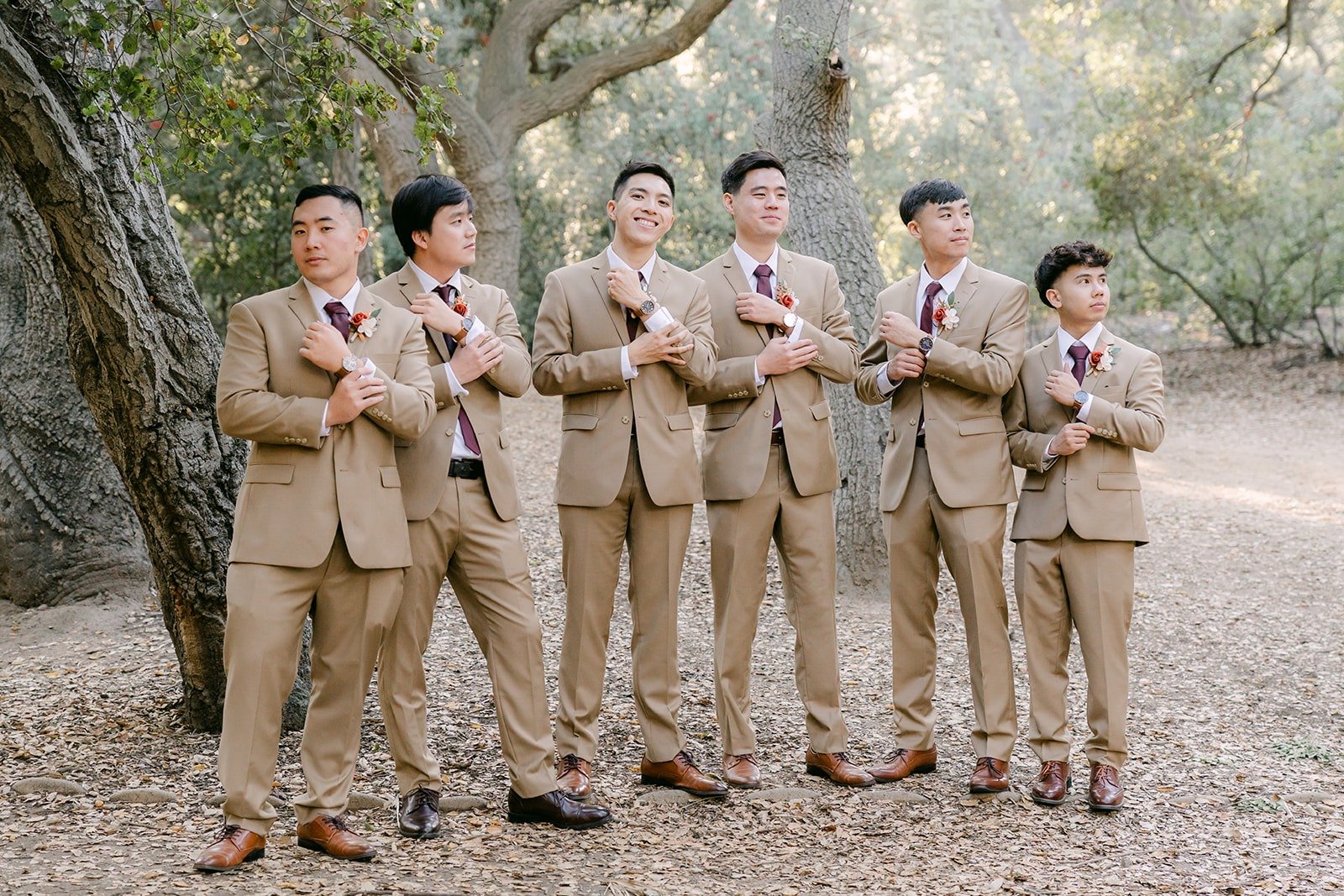 Groomsmen laughing together in tan suits