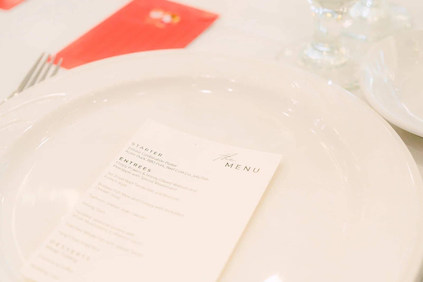 Menu card tucked into a white place setting