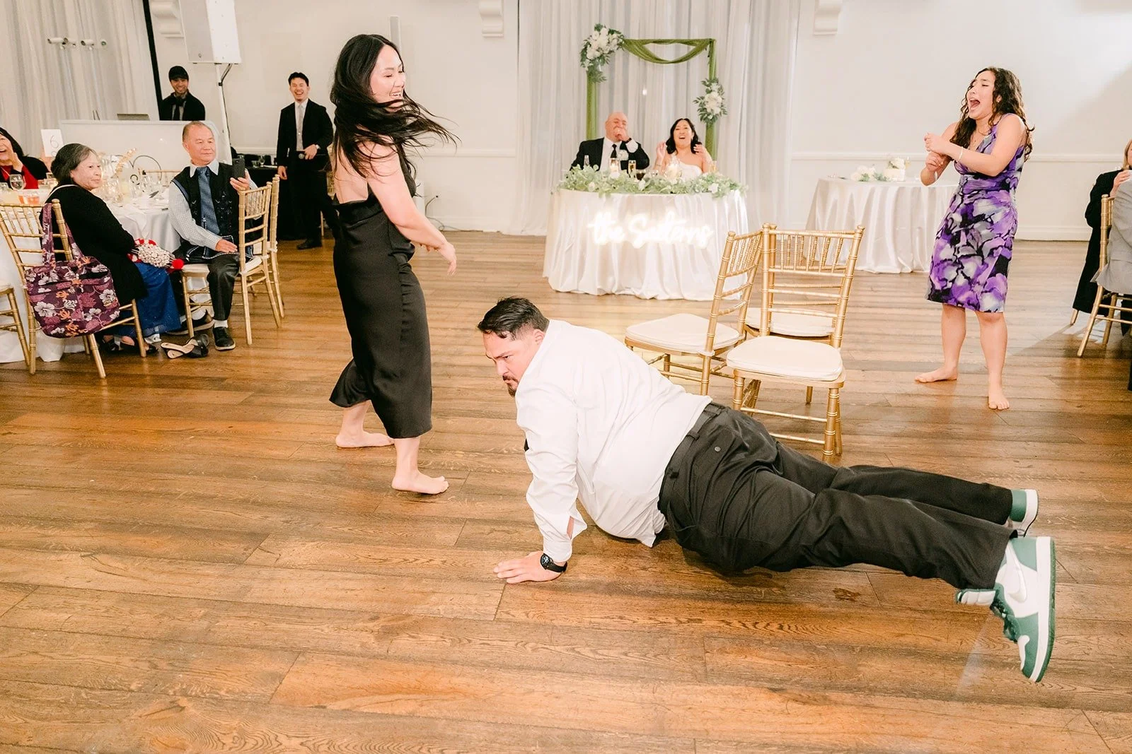A guest doing push ups on the dance floor during the games