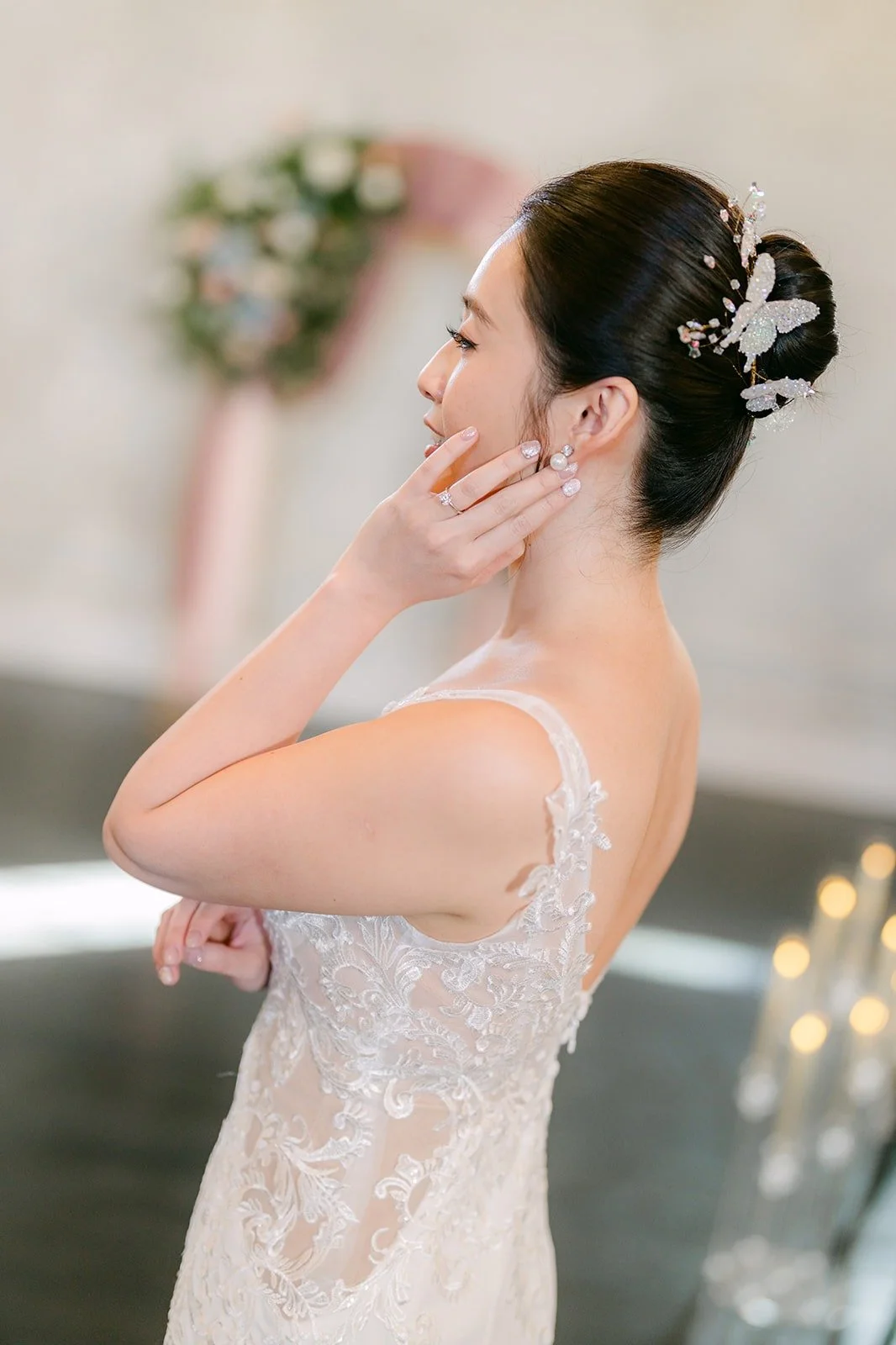 A profile of Elisa in her gown, with her hand resting at her ear