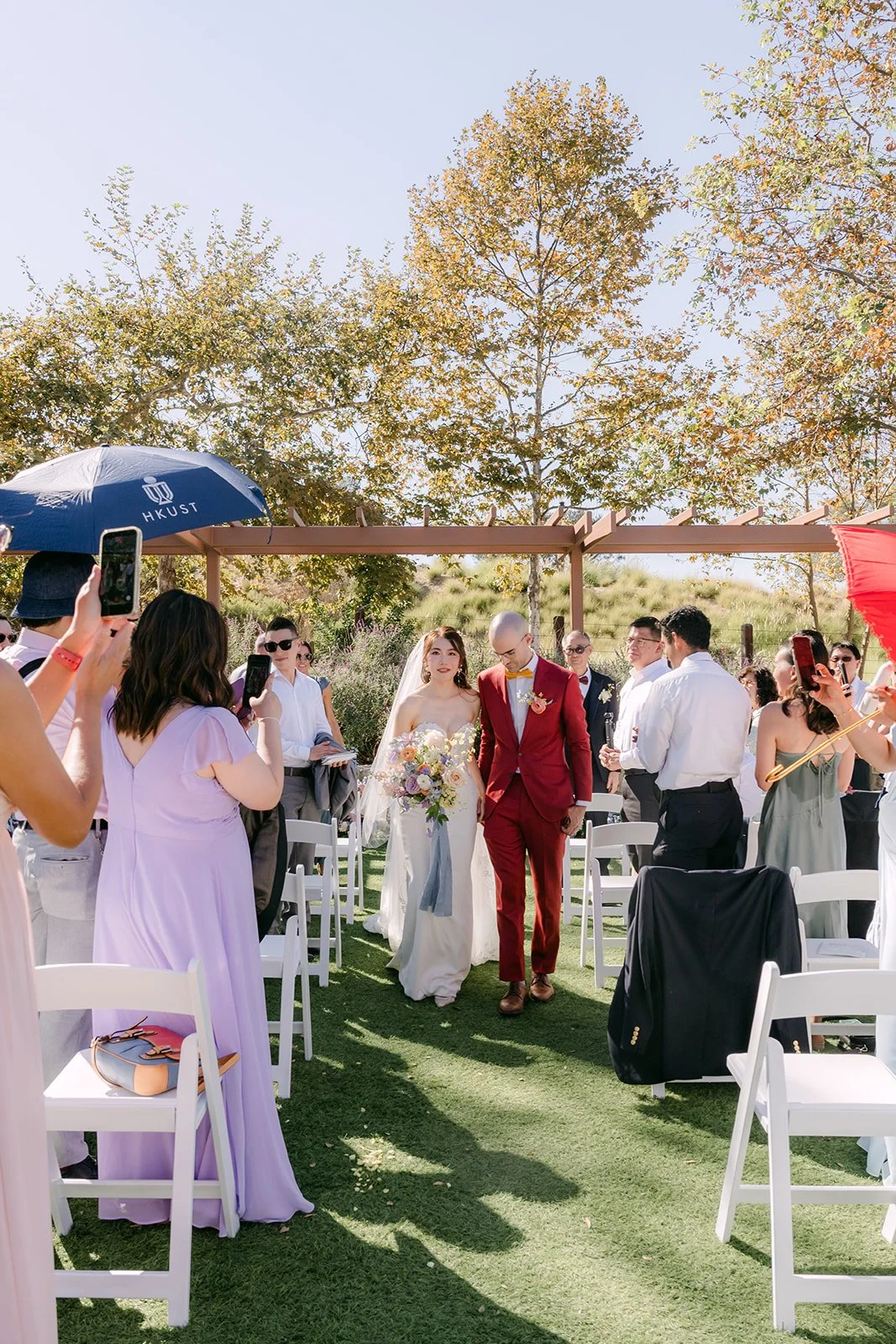 Guests cheer as Christie and Christian head back up the aisle.