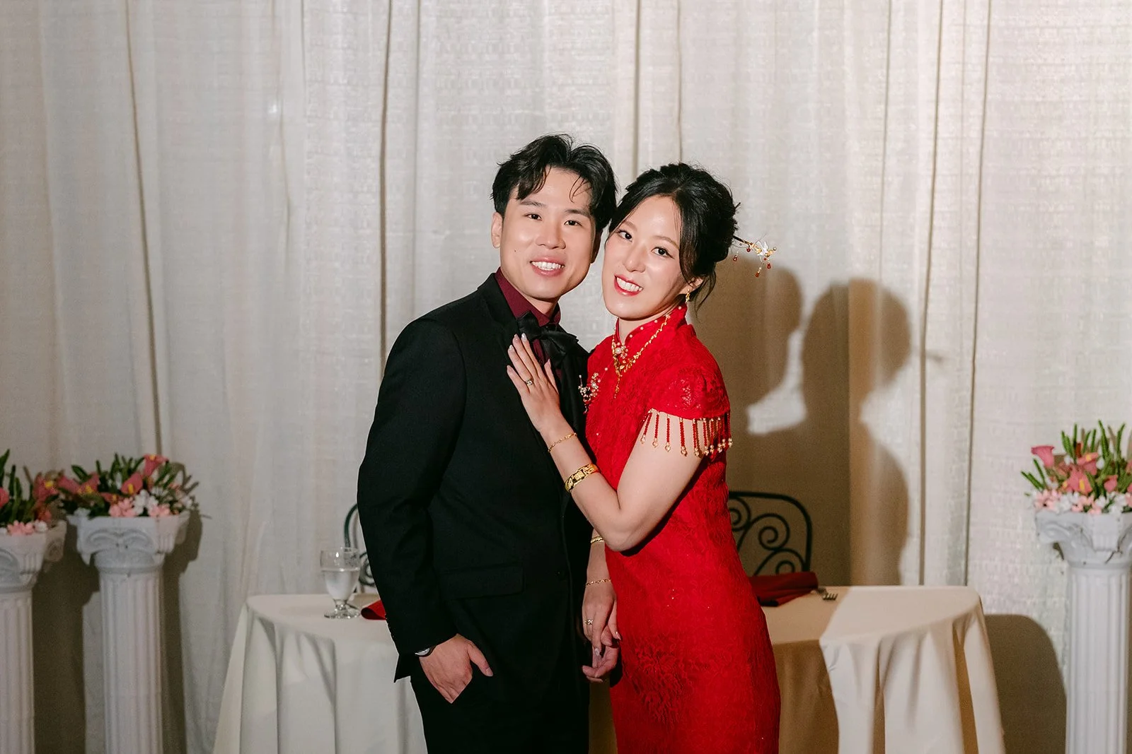 Elaine and Wen hugging under the string lights.