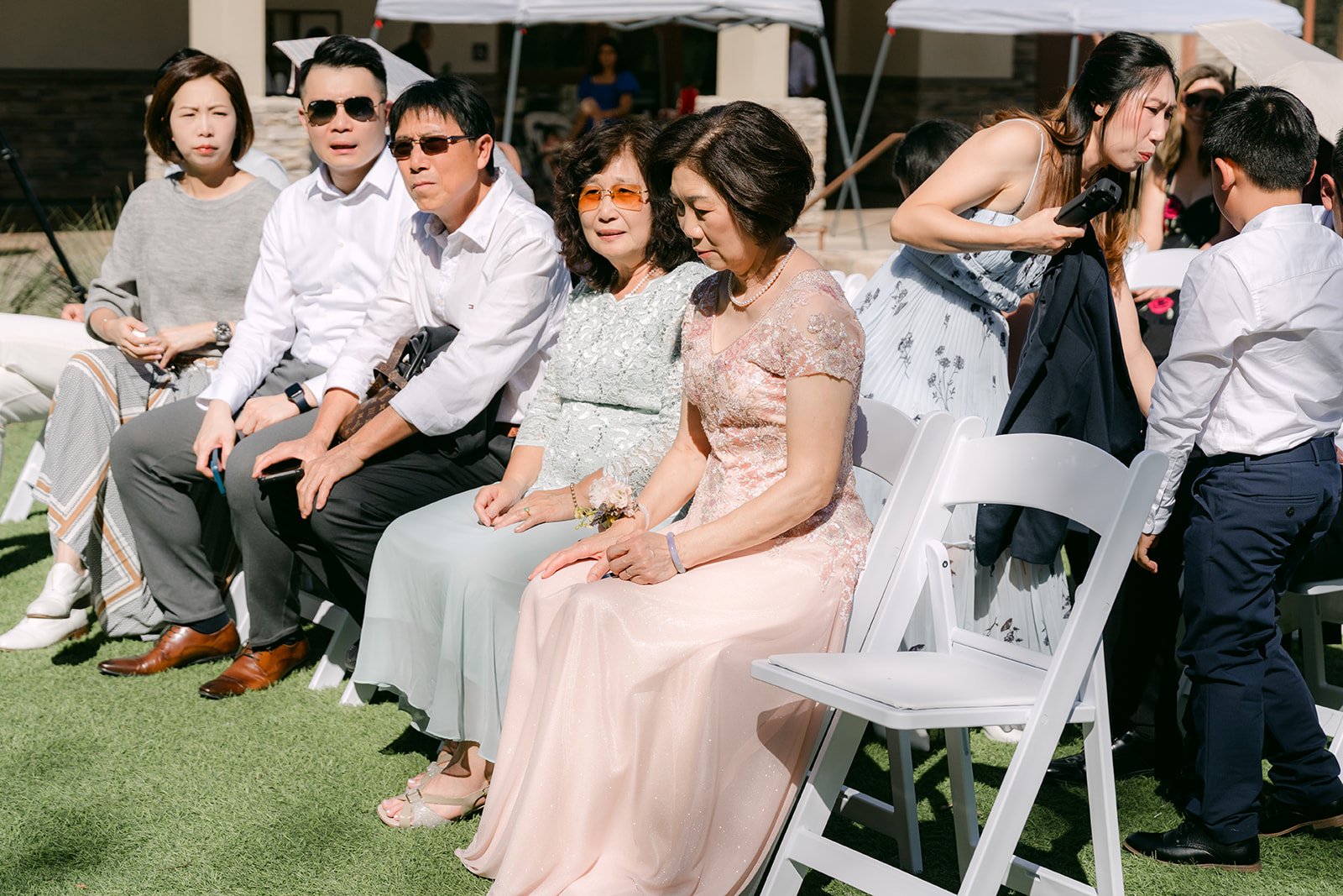 Guests take their seats on the lawn before the ceremony.