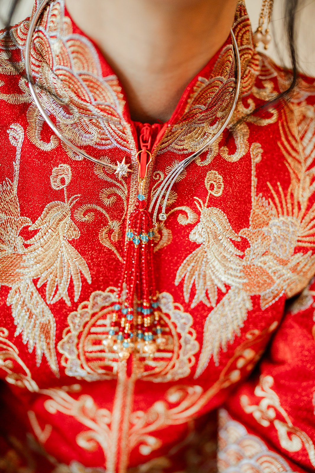 Close up of the gold dragon and phoenix embroidery on the collar of a qun kwa, photographed by One and Only Production.