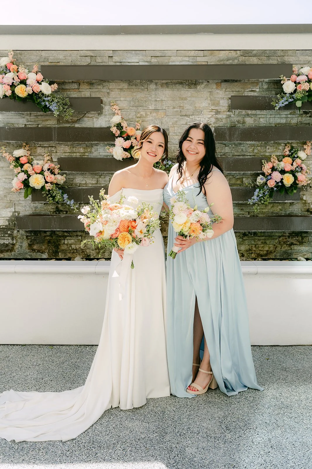 Amanda and a bridesmaid posing together on the terrace.