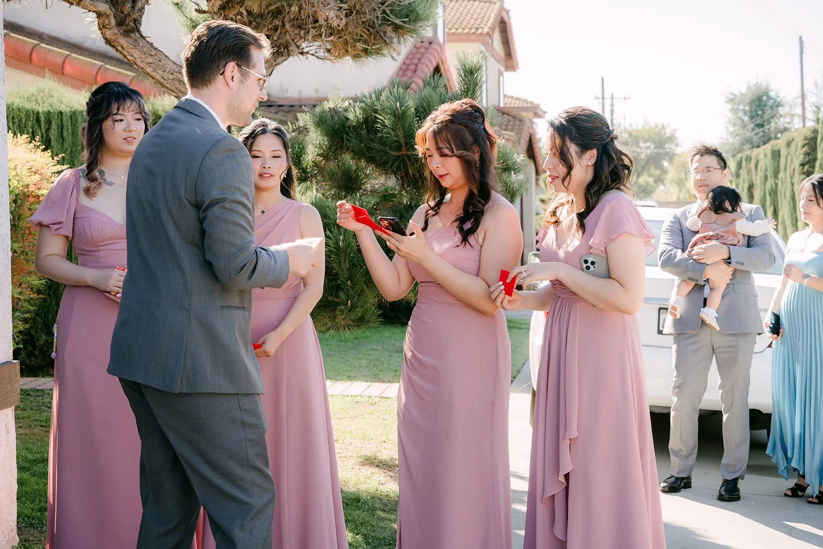Ken facing the bridesmaids at the door.