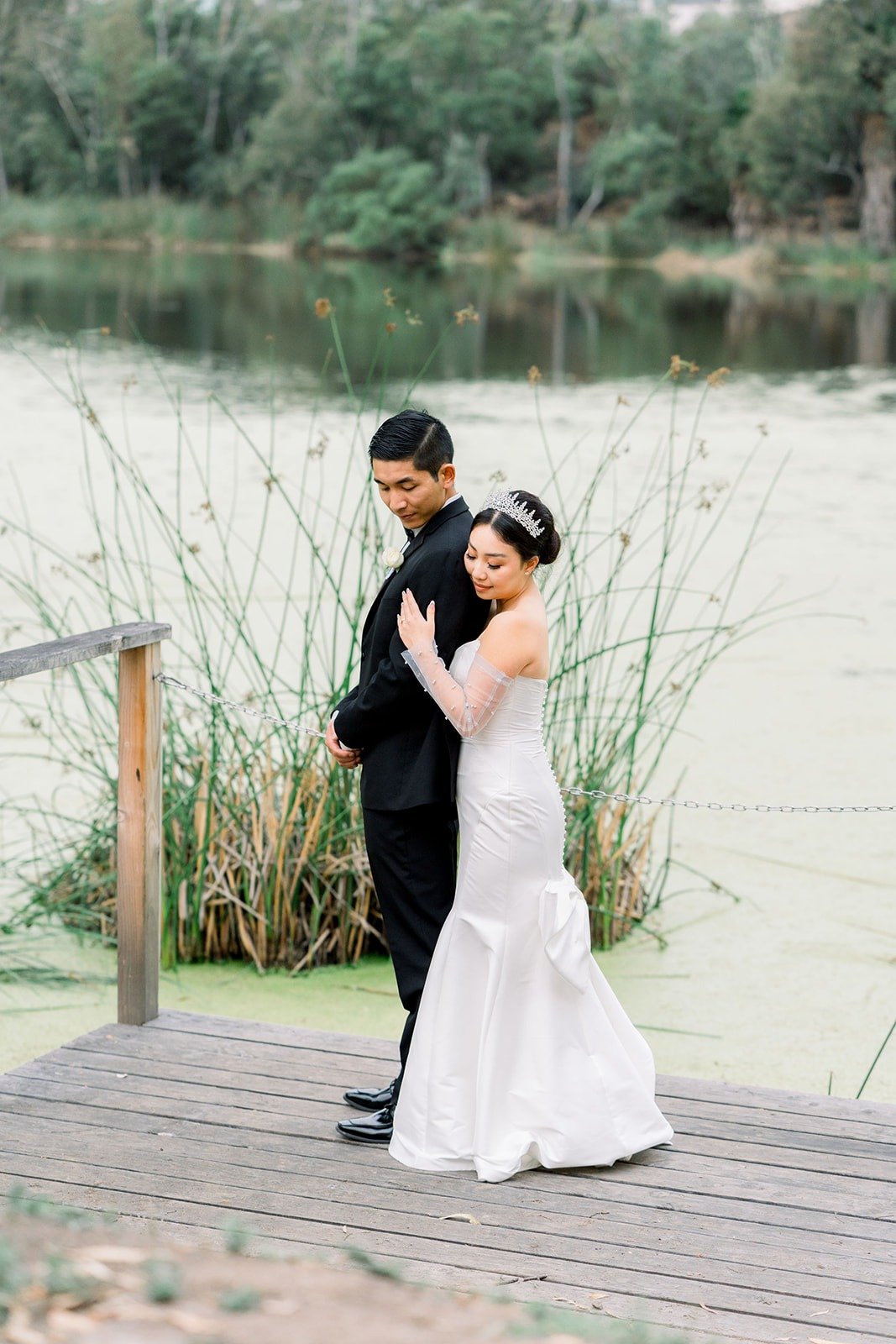 Steven and Jacinda on a wooden dock by the pond
