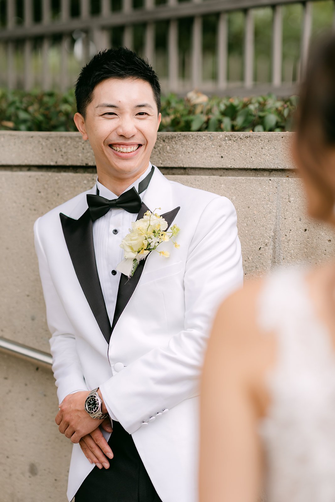 Ryan smiling in his white tuxedo jacket and bow tie.