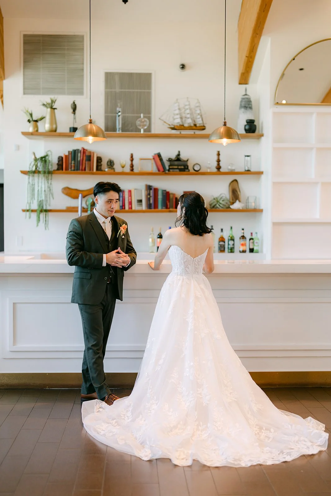 Alex holding Vivian's hand by the bar