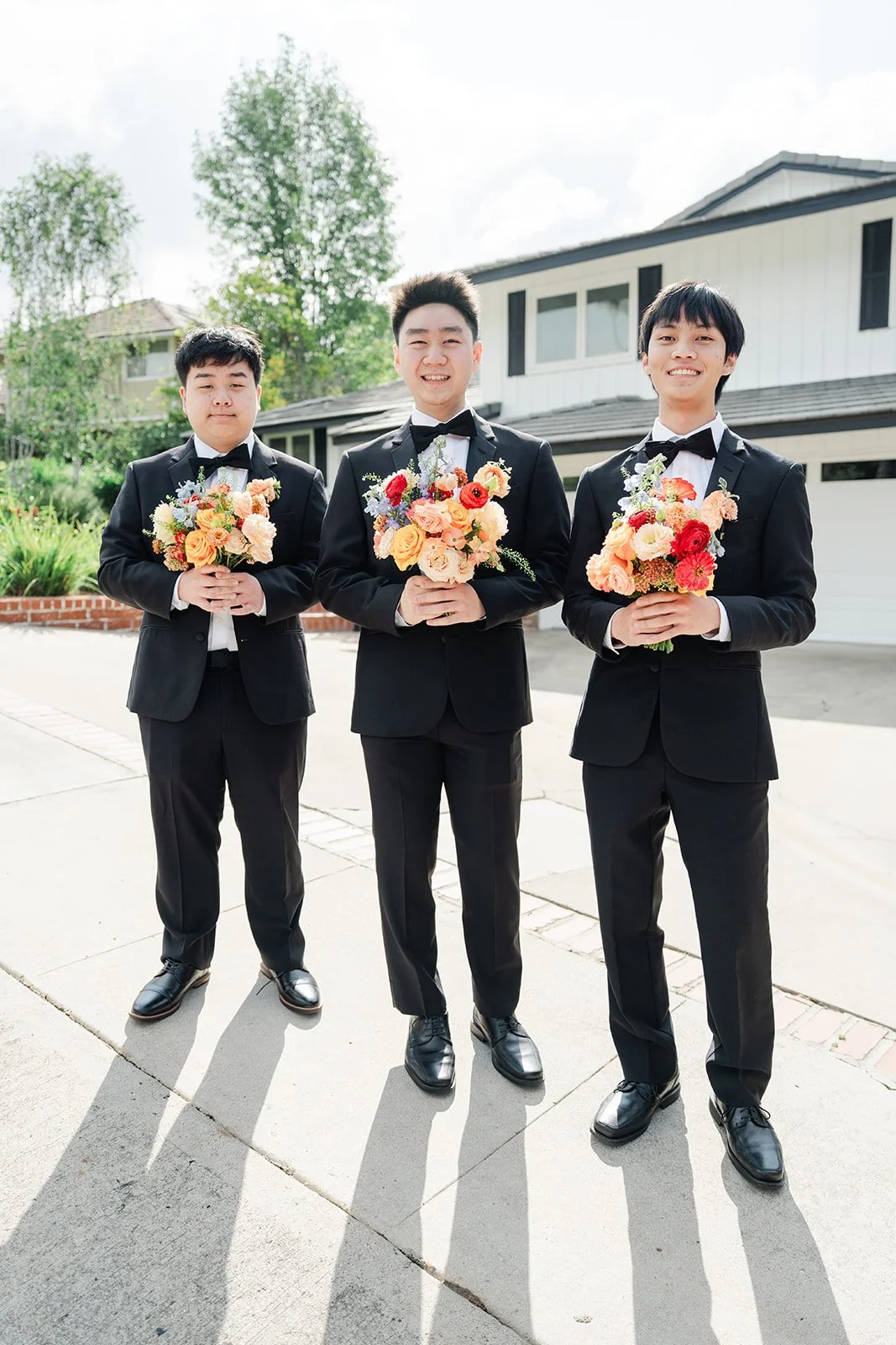 Henrik and his groomsmen lined up with bouquets.