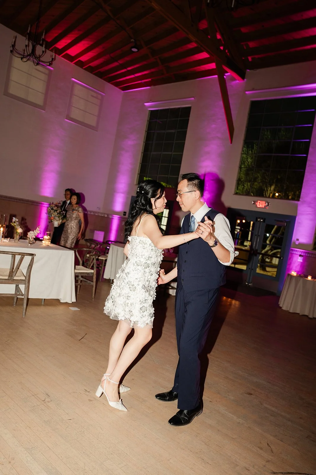 Constance and Lawrence dancing under colored lights