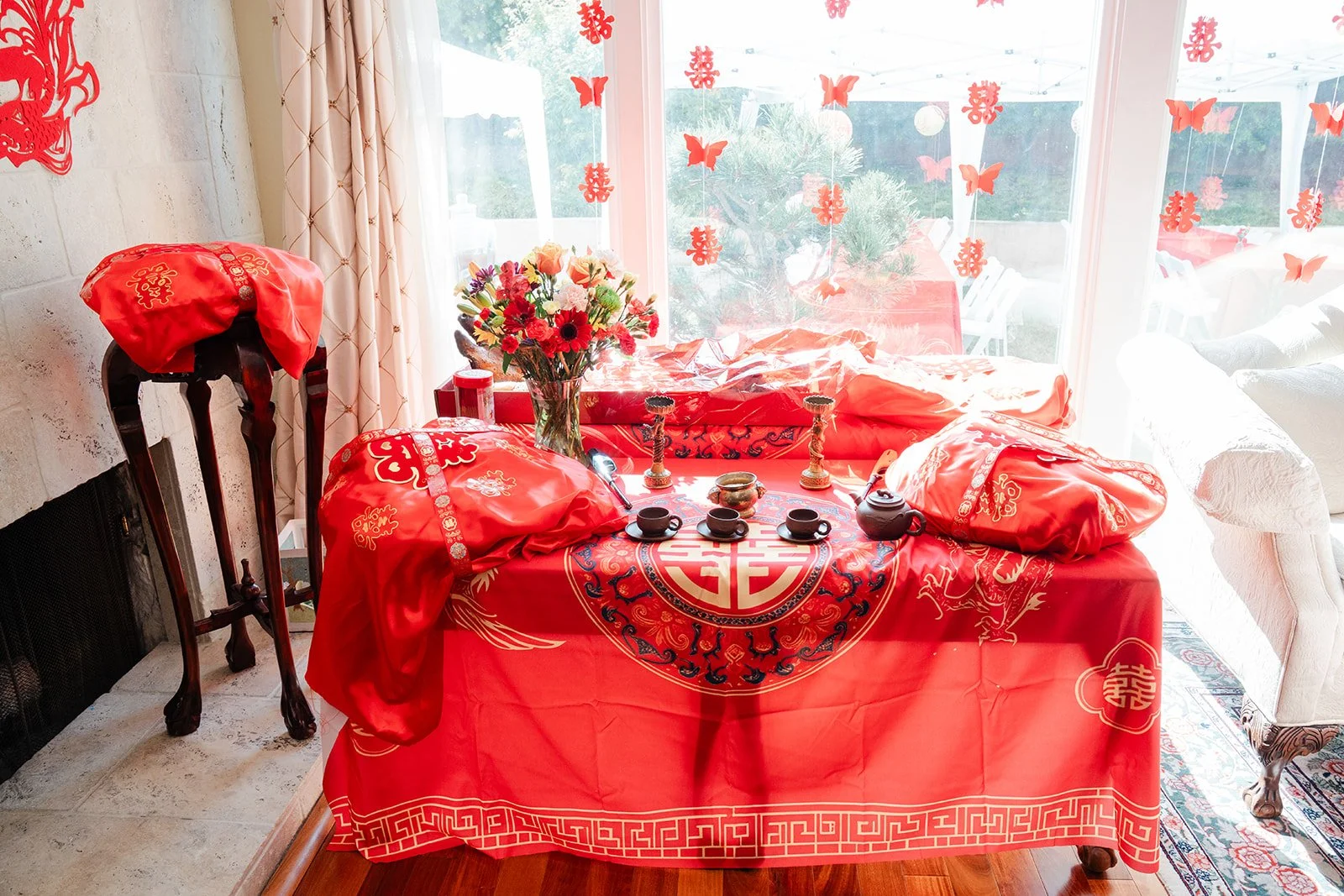 The tea ceremony table set with a red cloth by the window.