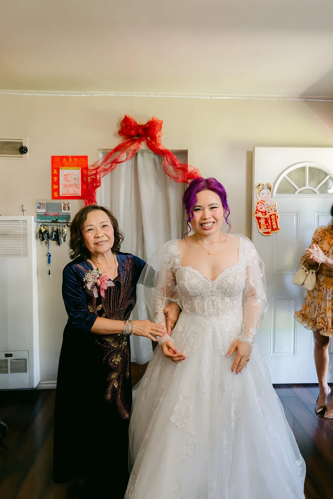 Vanessa's mom bringing her out through the curtained doorway.