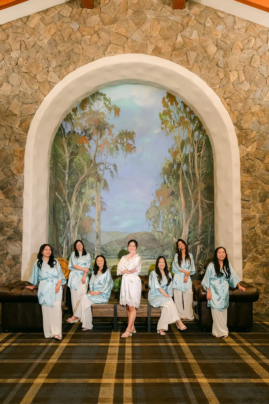 Bridesmaids in matching blue robes with Jessica