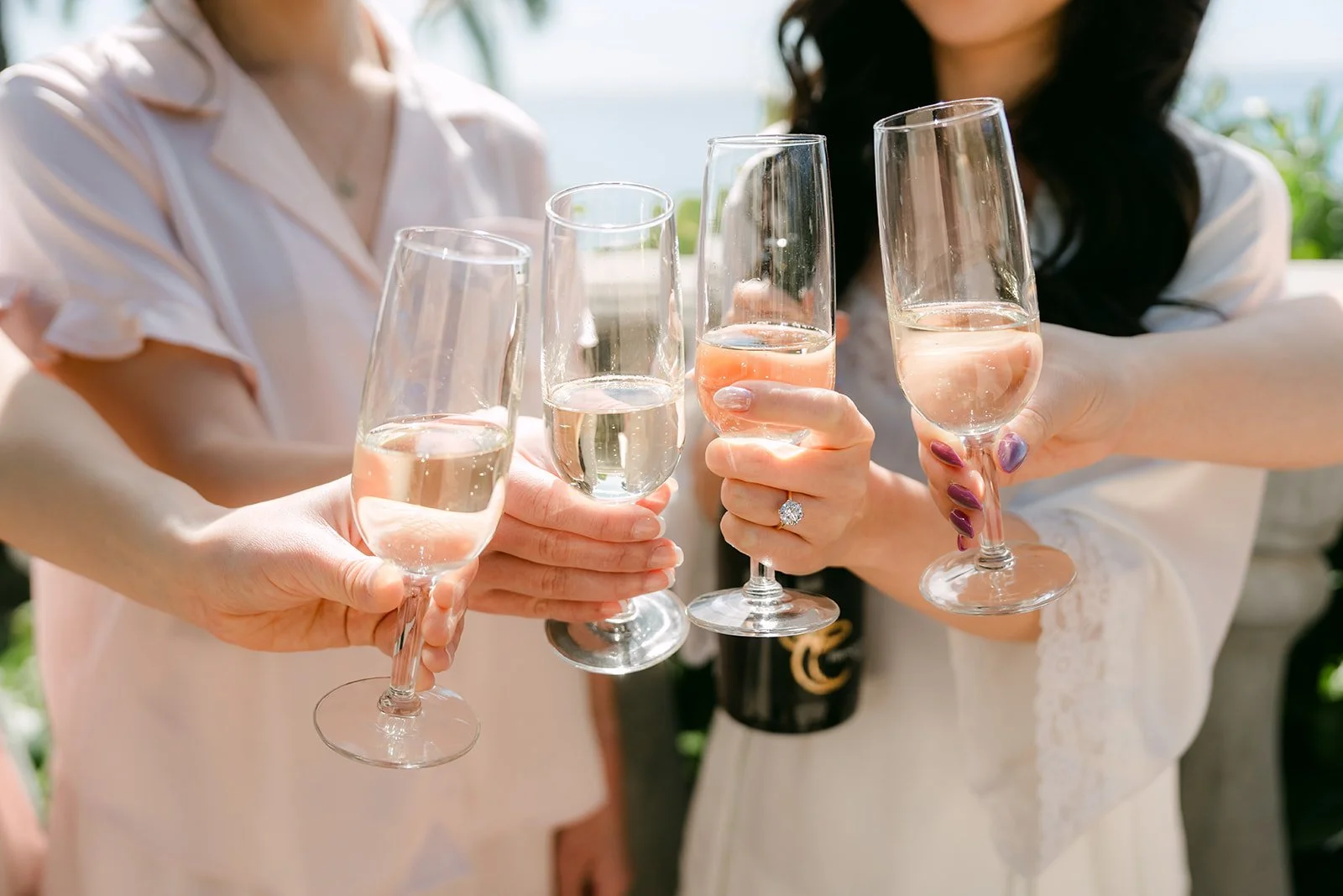 Champagne toast between the bride and her bridesmaids