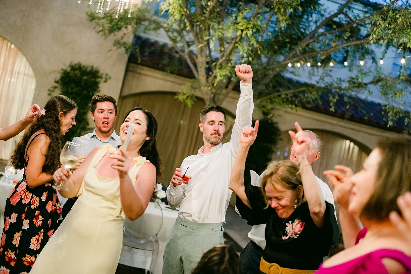 Guests dancing and cheering on the dance floor
