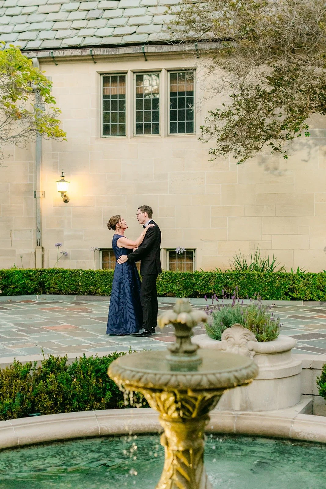 Nik dancing with his mom beside the fountain