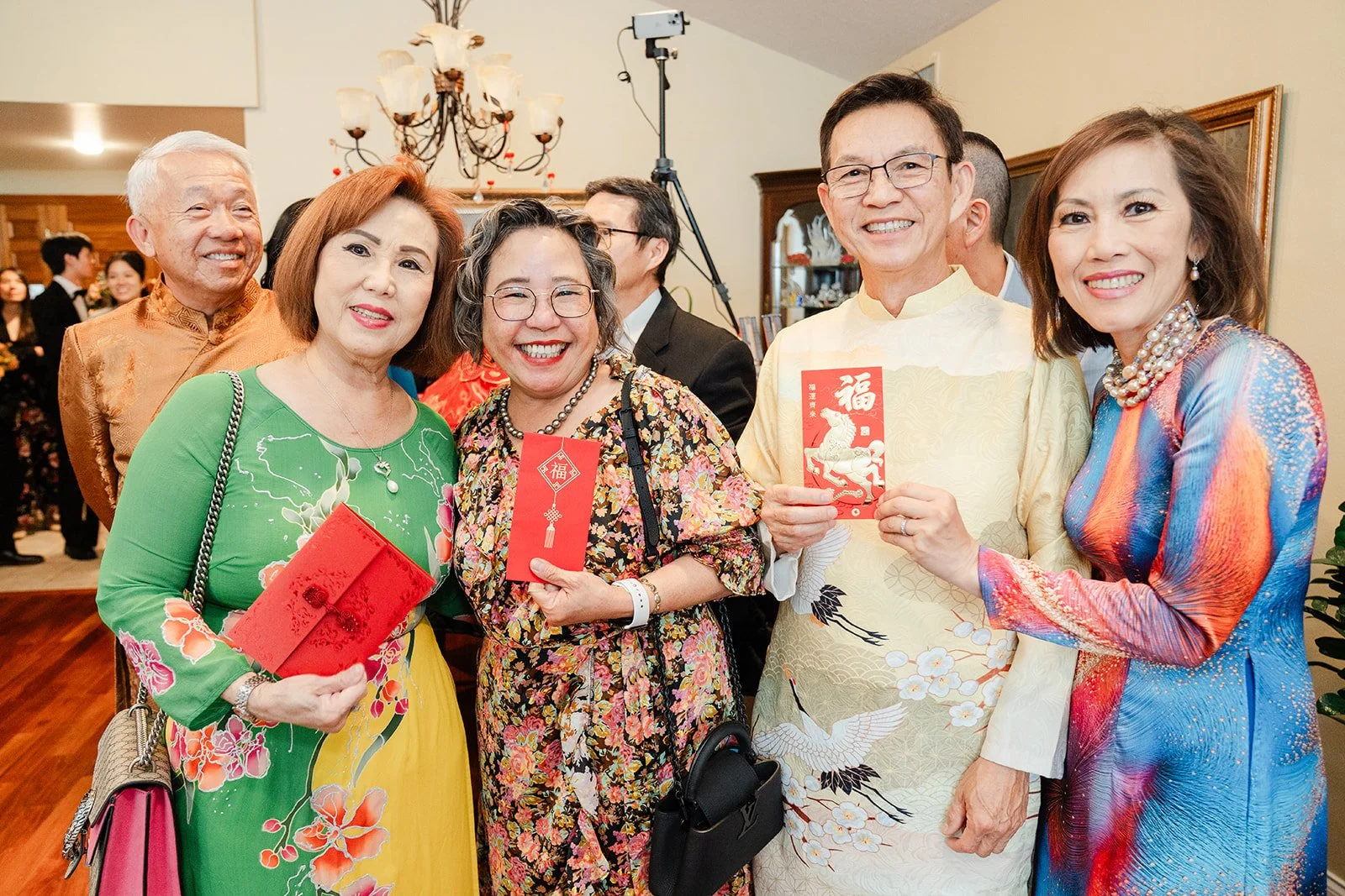 Relatives laughing with red envelopes in hand.