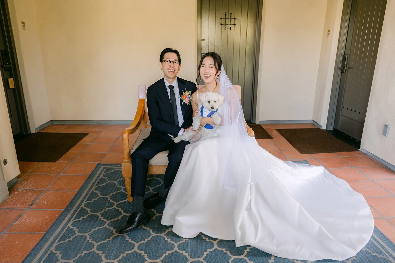 The couple seated with Soup inside the Spanish-style hallway