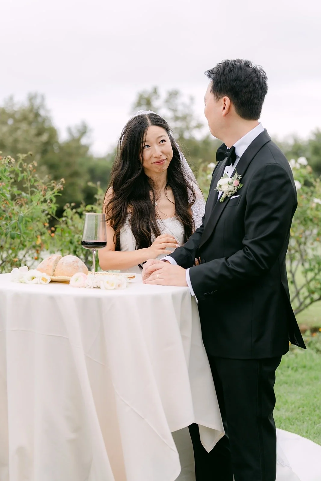Kristine and William sharing communion at a table during the ceremony