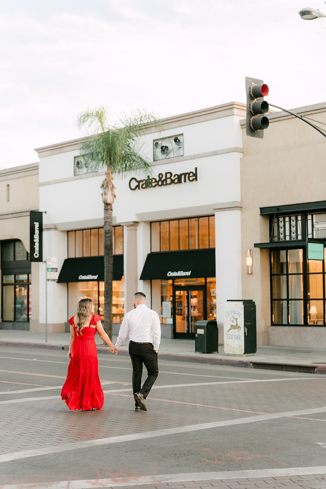 Linh leads Ankush across the crosswalk in Old Town Pasadena.