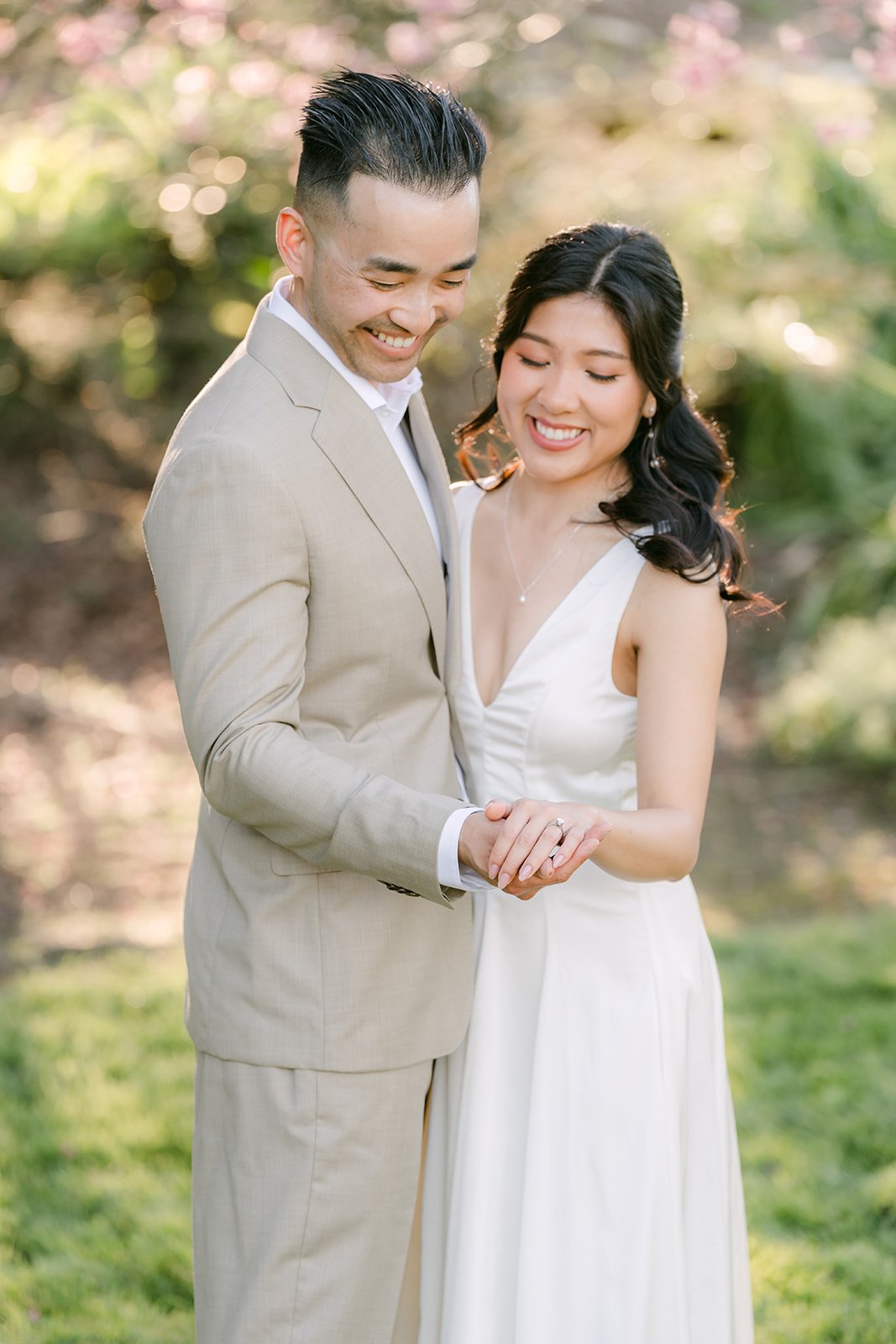 Kim and Vincent laughing as they hold hands.