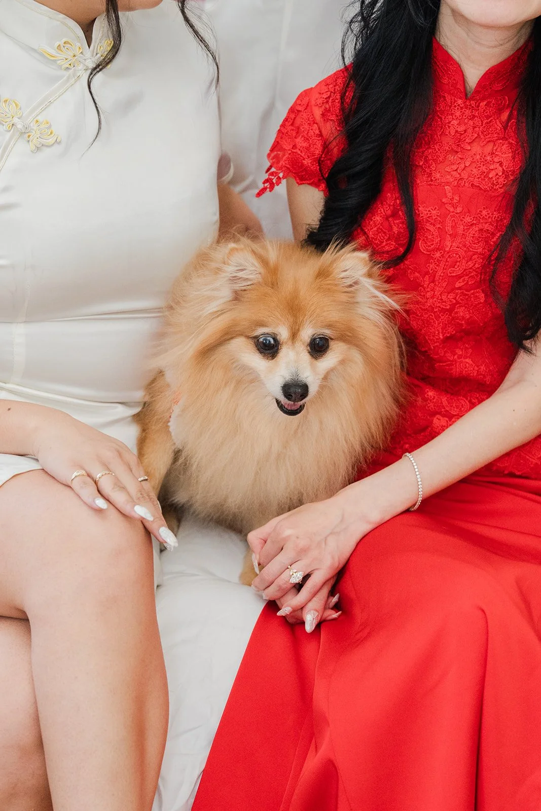 Valerie holding Kohmie in her red qipao.